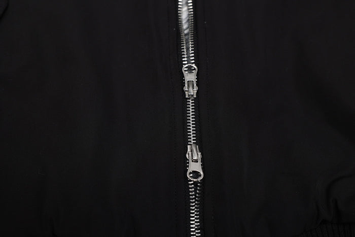 Close-up of black bomber jacket front zipper