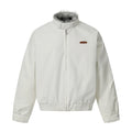 Off-white bomber jacket with grey faux-fur stand collar, front zip closure, and brown leather logo patch on chest