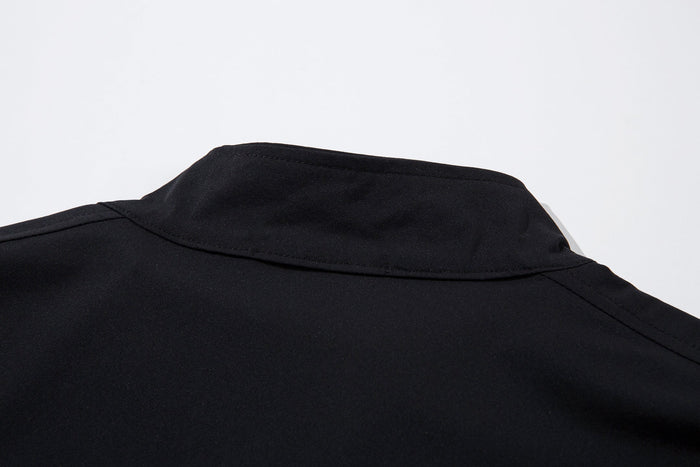 Close-up of the black stand collar and top seam on the track jacket