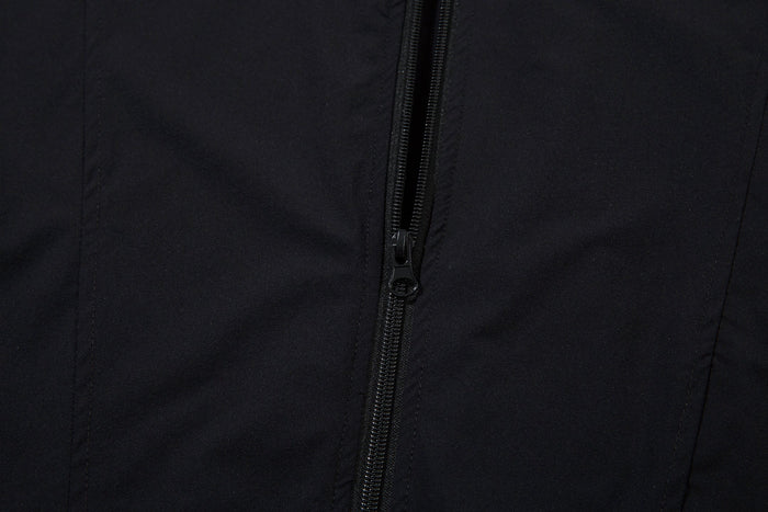 Close-up of the front zipper on the black track jacket