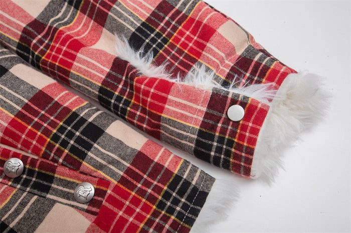 Close-up of red plaid jacket sleeve cuff with white faux fur trim