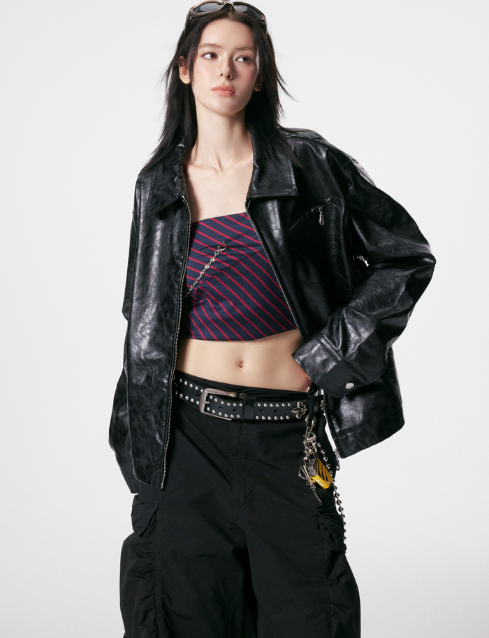 Model front view wearing black crinkle PU leather jacket with wide collar and chest zipper pocket
