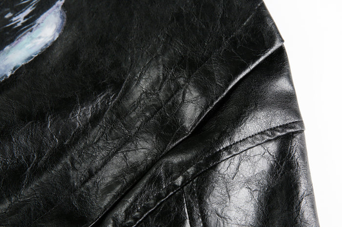 Close-up of black crinkle PU leather shoulder and sleeve texture