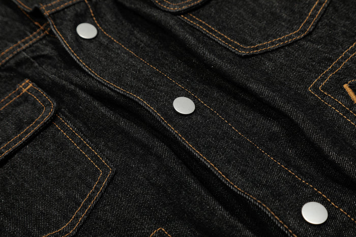 Close-up of the jacket front with snap buttons and stitched chest pockets