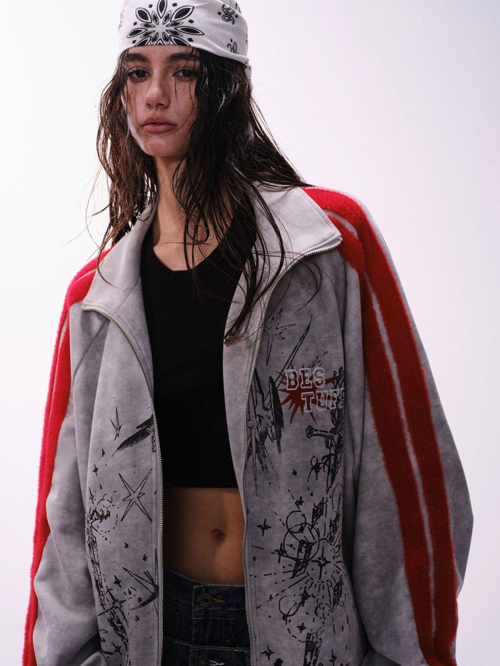 Model wearing a gray graphic track jacket with red striped sleeves, open front, and bandana headscarf