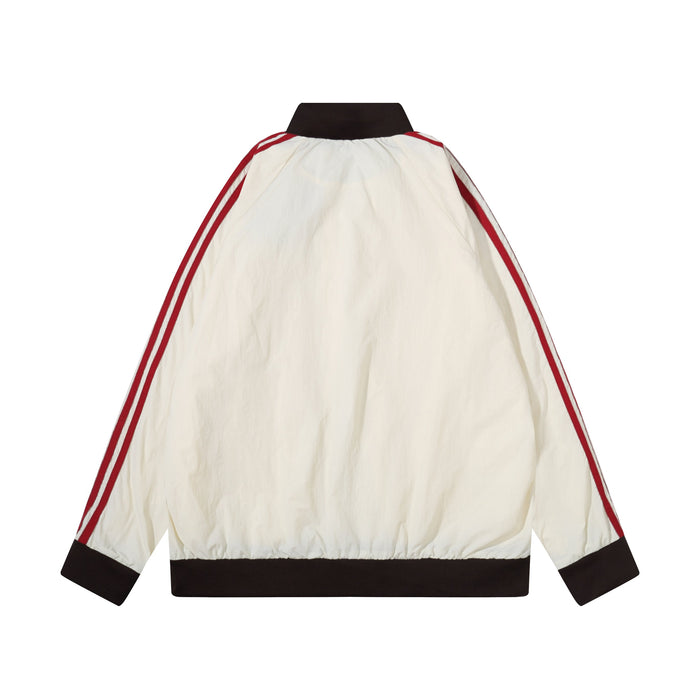 Back view of cream nylon track jacket with red triple stripes and dark brown collar and hem