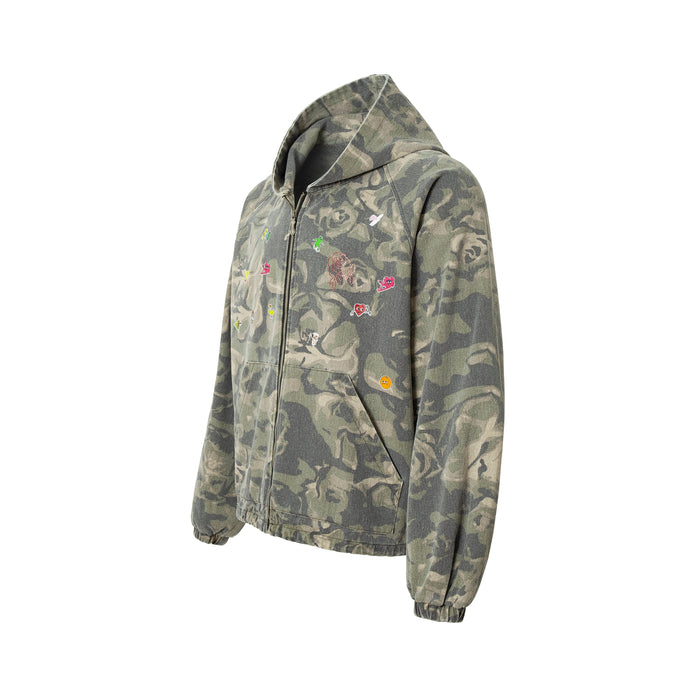 Front angled view of rose camo zip-up hoodie with embroidered patches and front pockets