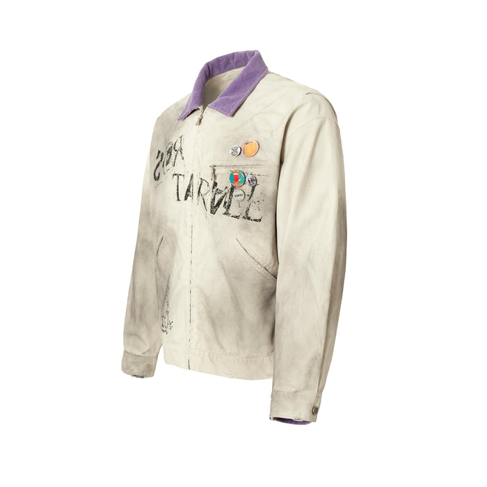 Three-quarter front view of beige graphic jacket with purple collar and chest pins