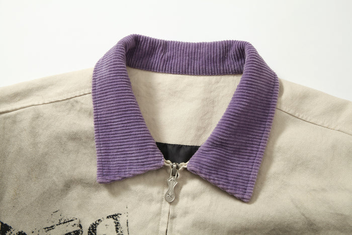 Close-up of purple corduroy collar and metal zipper on beige jacket