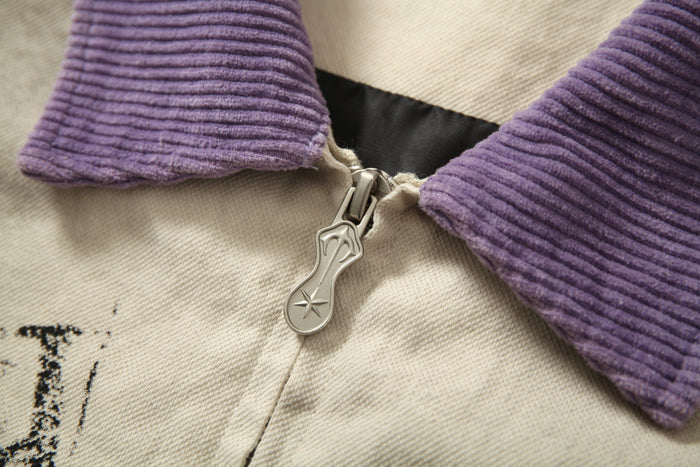 Close-up of jacket zipper pull and purple ribbed collar