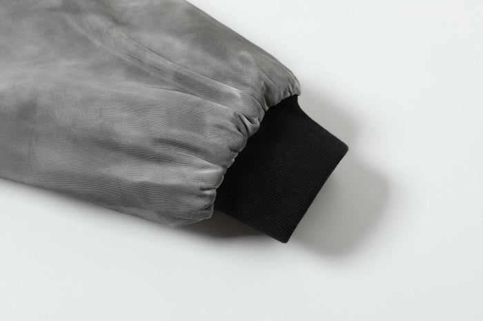 Grey bomber jacket sleeve cuff with black ribbed knit trim