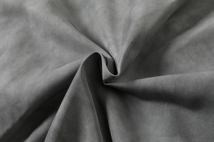 Close-up of washed grey suede-look fabric with soft matte texture