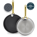 Set of two gold-handled frying pans with white ceramic interiors, sizes 10 and 12 inches.