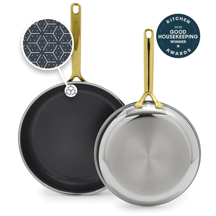 Set of two gold-handled frying pans with white ceramic interiors, sizes 10 and 12 inches.