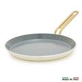 White crepe pan with a gold handle on a white background