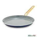 Blue crepe pan with a gold handle on a white background