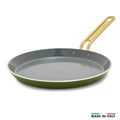Green crepe pan with a gold handle on a white background