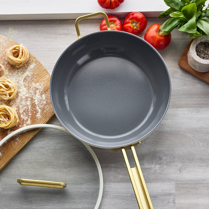 White ceramic 4.5-quart nonstick pan with handles on both sides, shown empty on a plain surface.