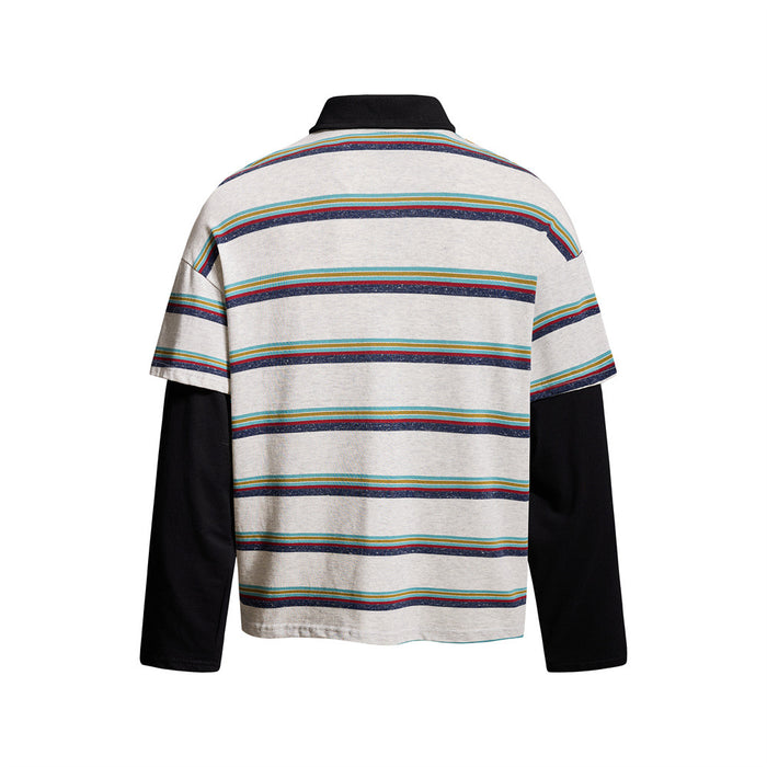 Back view of light gray striped polo shirt with black collar and layered black sleeves