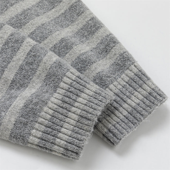 Close-up of the ribbed sleeve cuff on a gray striped knit cardigan