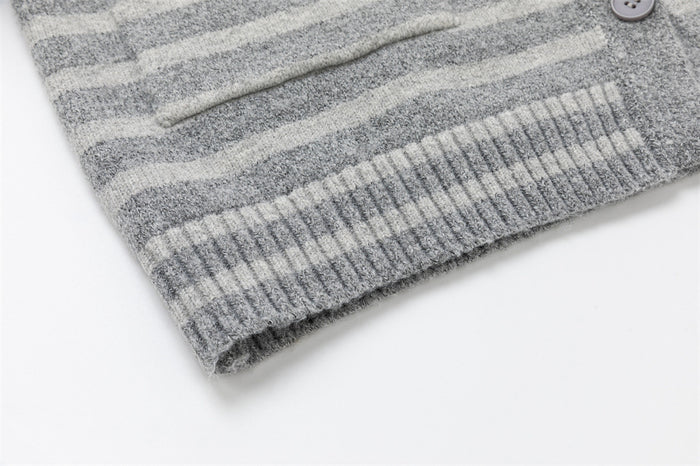 Close-up of the ribbed hem on a gray striped knit cardigan