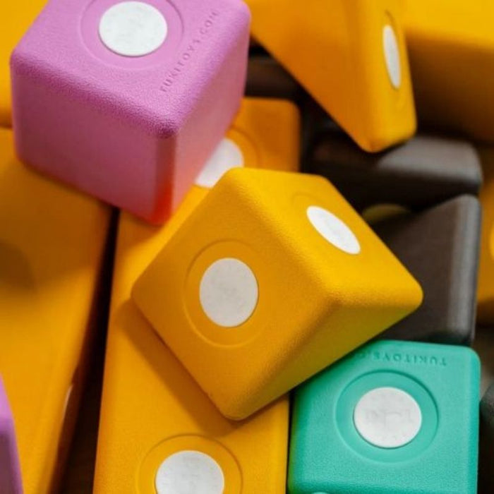 Close-up view of TUKI BIG Smart Magnetic Blocks Smart 10 showing the large 10cm EVA foam block construction, waterproof rotating neodymium magnet capsules, and the 3 Smart TUKI shapes including the pyramid that distinguish the SMART range from all BUILDER sets