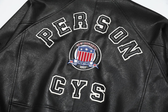 Close-up of black bomber jacket back showing PERSON lettering and central patch