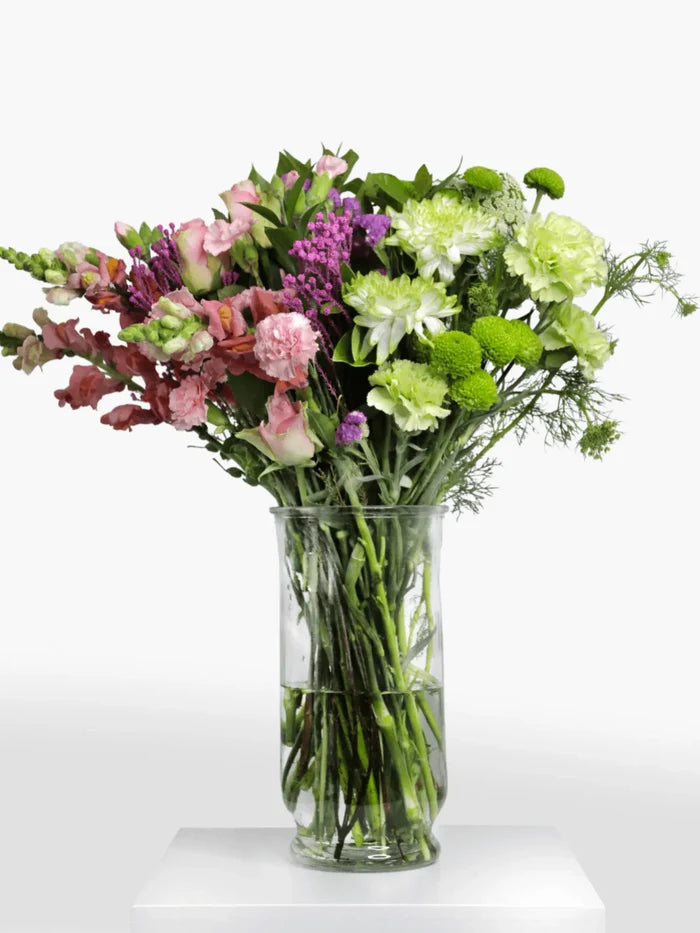 Wicked-ly Wonderful flower arrangement with vibrant pink and green blooms in a clear vase.