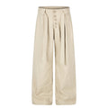 Beige wide-leg pleated trousers with button fly and self-tie belt, front and back views
