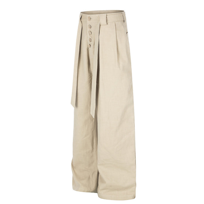 Beige wide-leg trousers with pleated front, side button fly, and waist belt ties