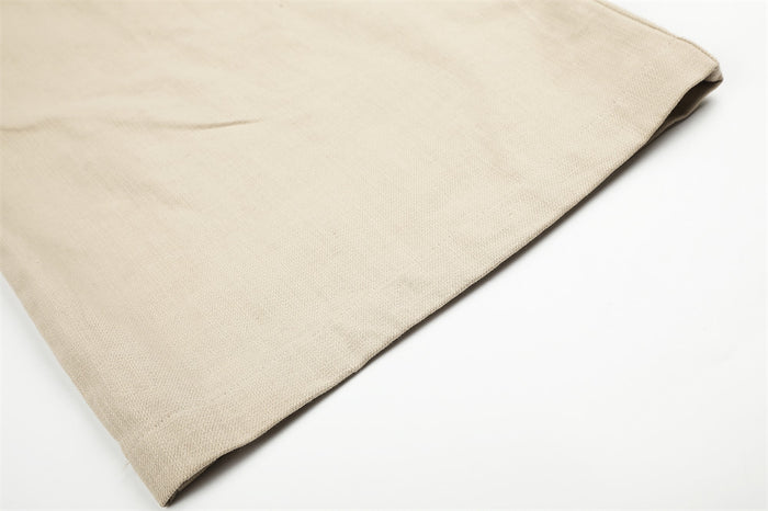 Close-up of beige trouser hem with wide-leg cuff and textured fabric