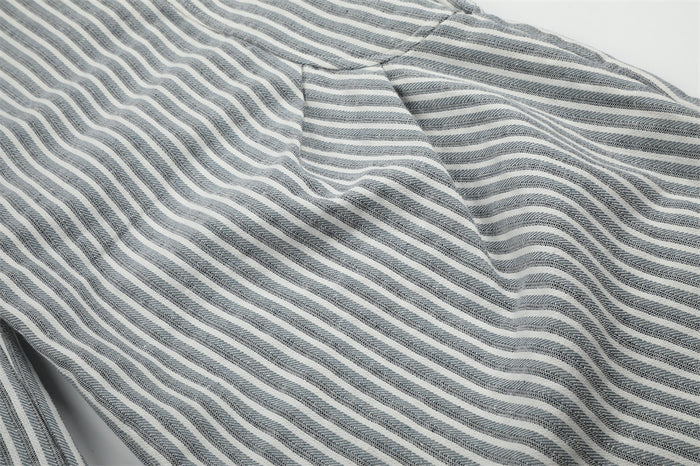 Close-up of side hip and leg seam on gray striped pants