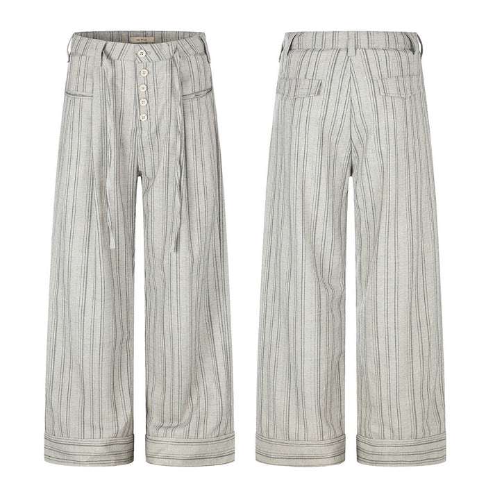 Men's wide-leg grey pinstripe trousers with button-fly, drawstring waist, patch pockets, and folded cuff hem, front and back