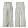Men's wide-leg grey pinstripe trousers with button-fly, drawstring waist, patch pockets, and folded cuff hem, front and back