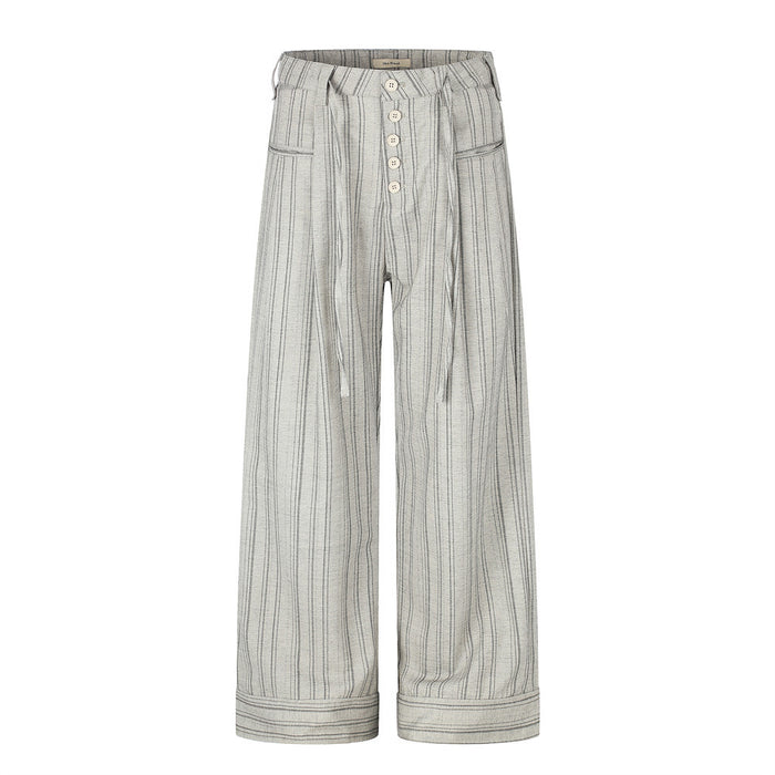 Front view of wide-leg gray striped trousers with button fly and pleated waist